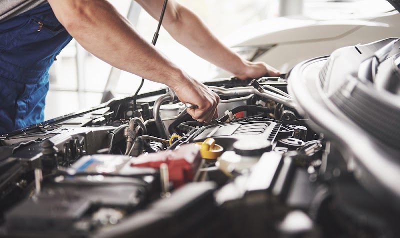 Auto mechanic working in garage. Repair service.